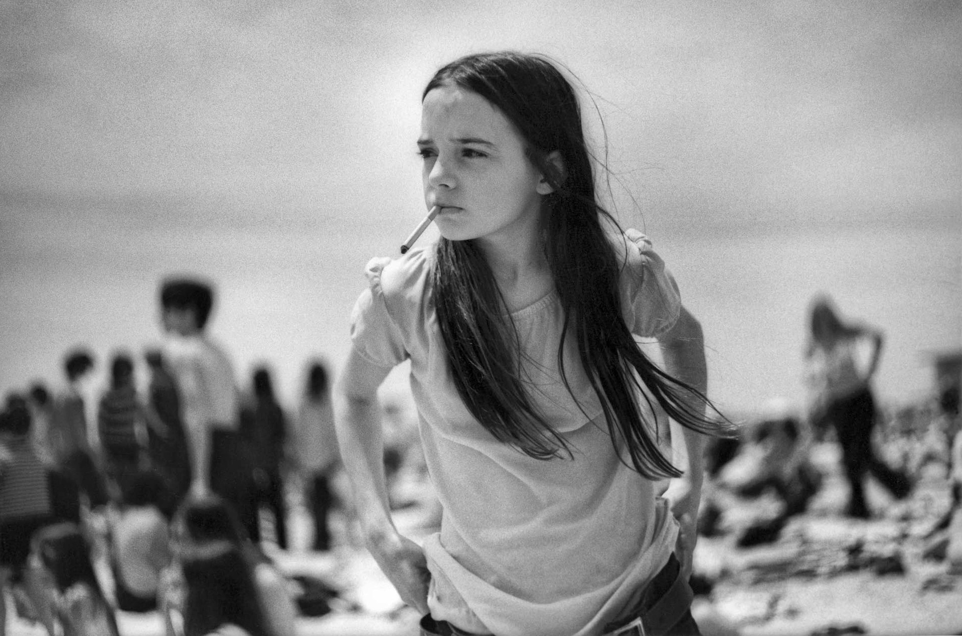 Priscilla, a young girl smoking a cigarette on Jones Beach, New York